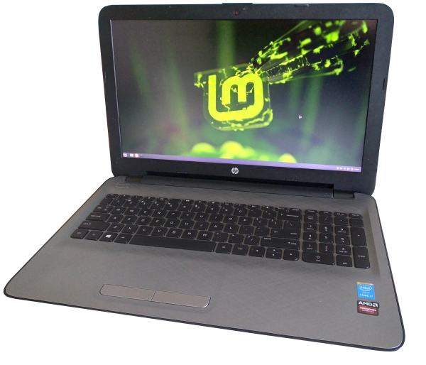 Photo of the HP Notebook 15-ac657TX open with a green Linux Mint wallpaper